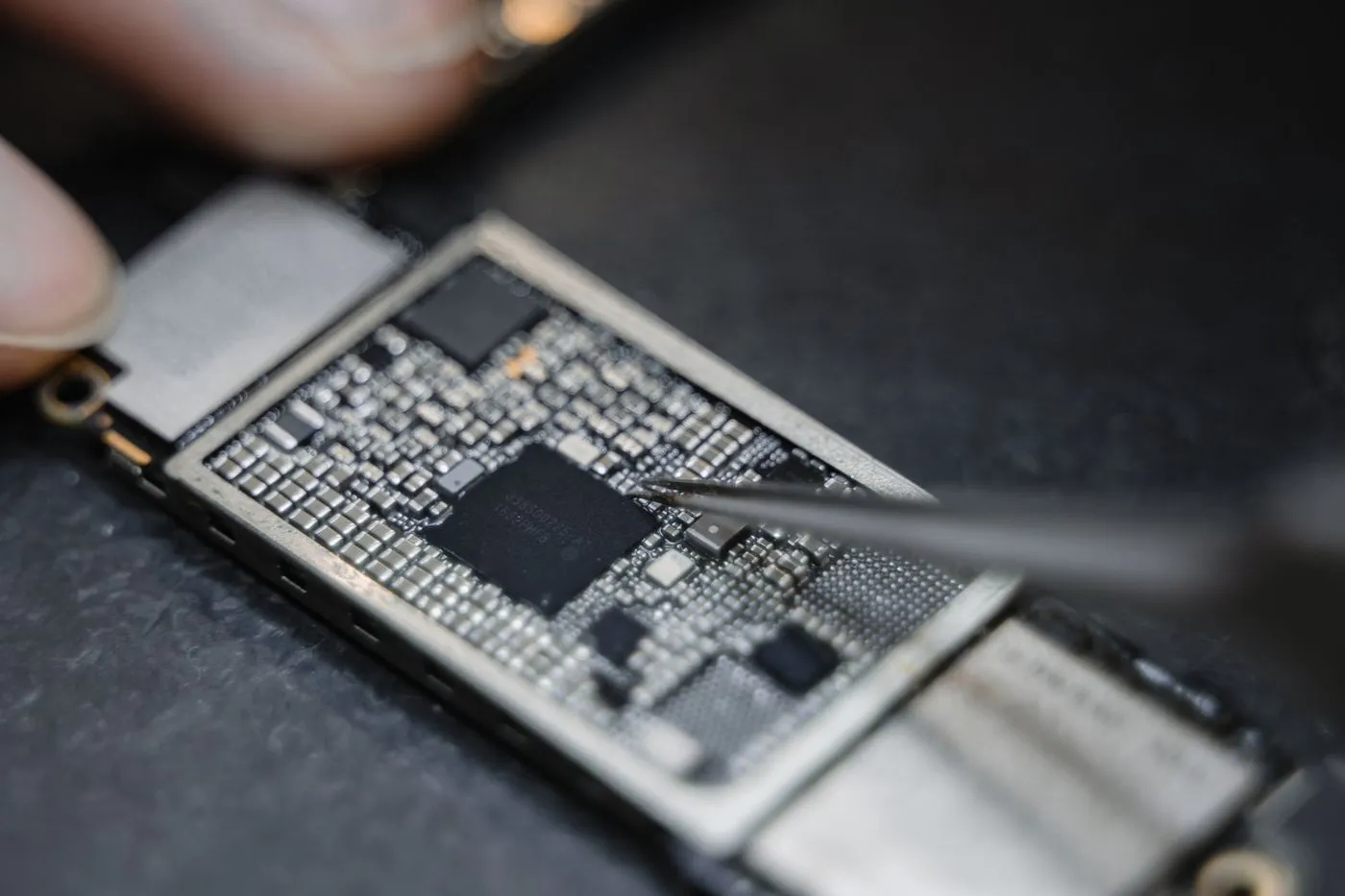 Close-up of a circuit board during device repair